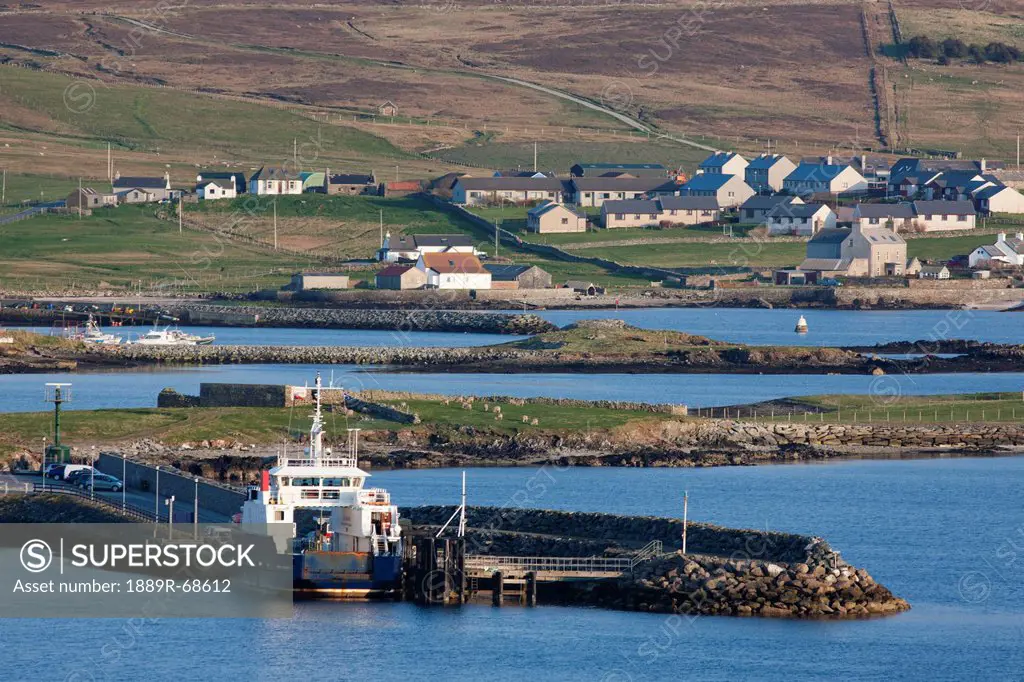 a woman walks on a sandy path to the coast, shetland scotland
