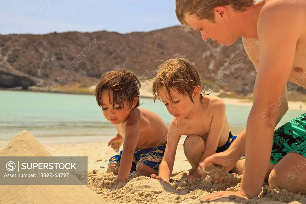 boys playing in the sand in los islotes national marine park on espiritu santo island, la paz baja california sur mexico