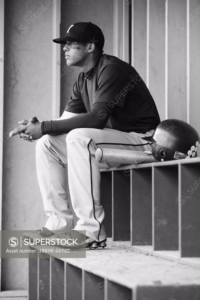 teenage boy baseball player sits watching, troutdale oregon united states of america