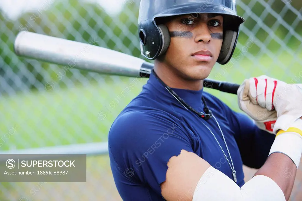 teenage boy baseball player wearing a batting helmet, troutdale oregon united states of america