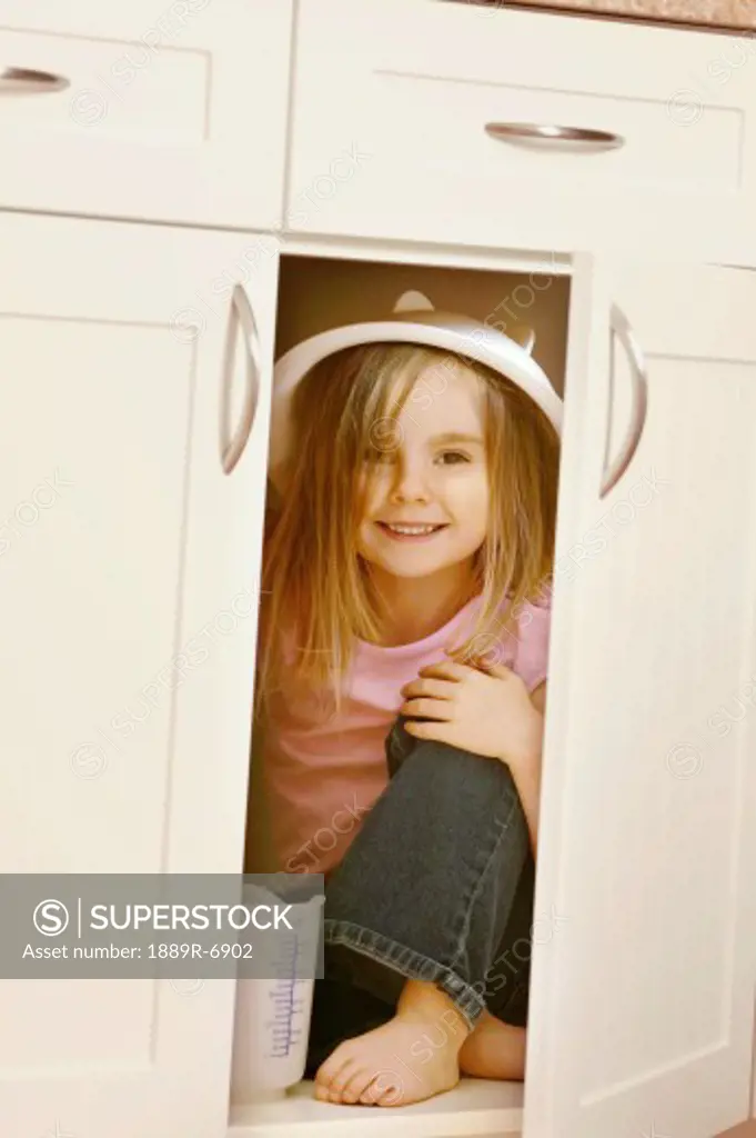 Child hides in kitchen cupboard