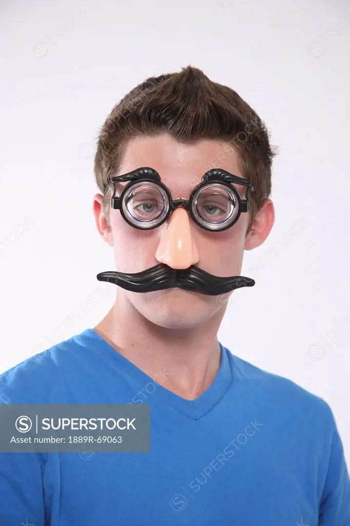 a teenage boy wearing a groucho marx mask, troutdale oregon united states of america
