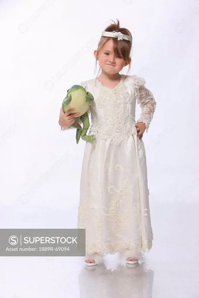 a young girl dressed as a princess in a white dress and holding a green frog, troutdale oregon united states of america