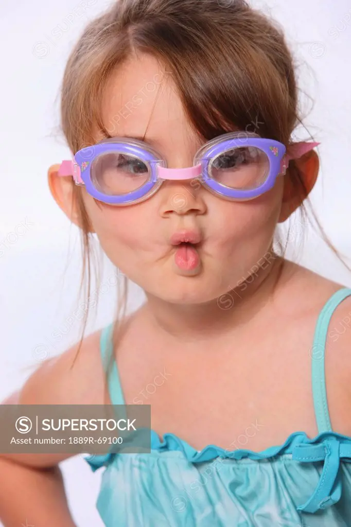 a little girl wearing swimming goggles and making a fish face with her lips, troutdale oregon united states of america