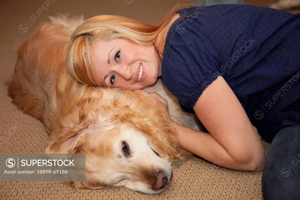 a young woman lays down with her dog, st. albert alberta canada
