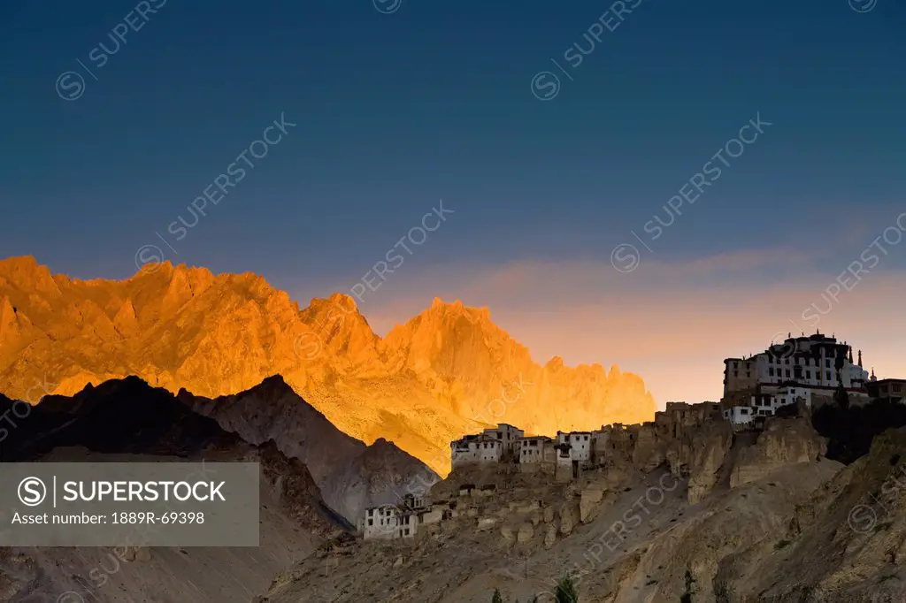 buildings on the edge of rock ledges beside the mountains, lamayuru ladakh india