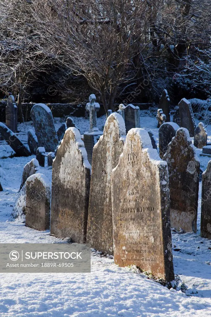 a cemetery covered in snow in winter, carrigaline county cork ireland
