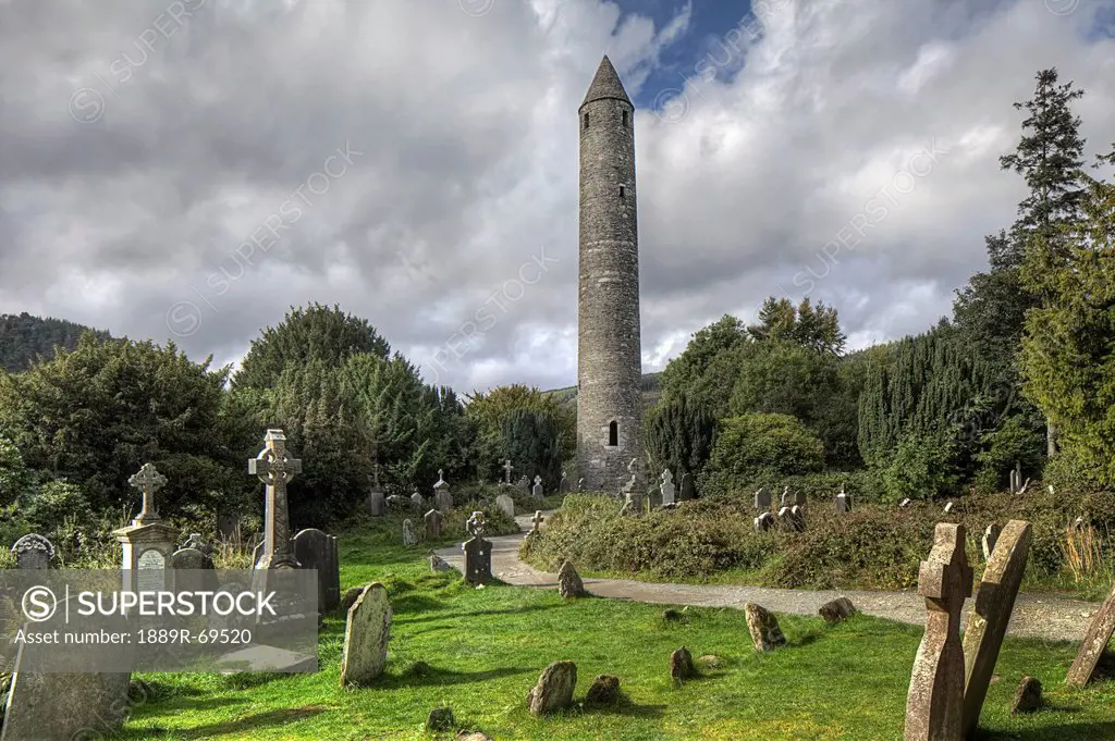 round tower in graveyard, glendalough county wicklow ireland