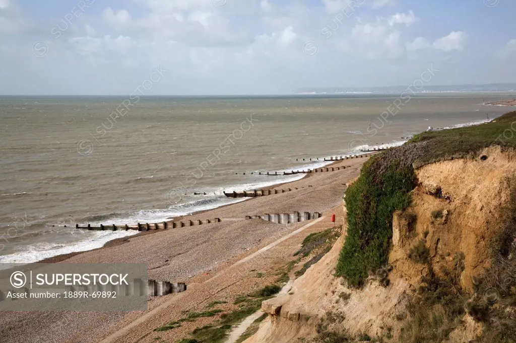 groynes along the coastline, bexhill, sussex, england