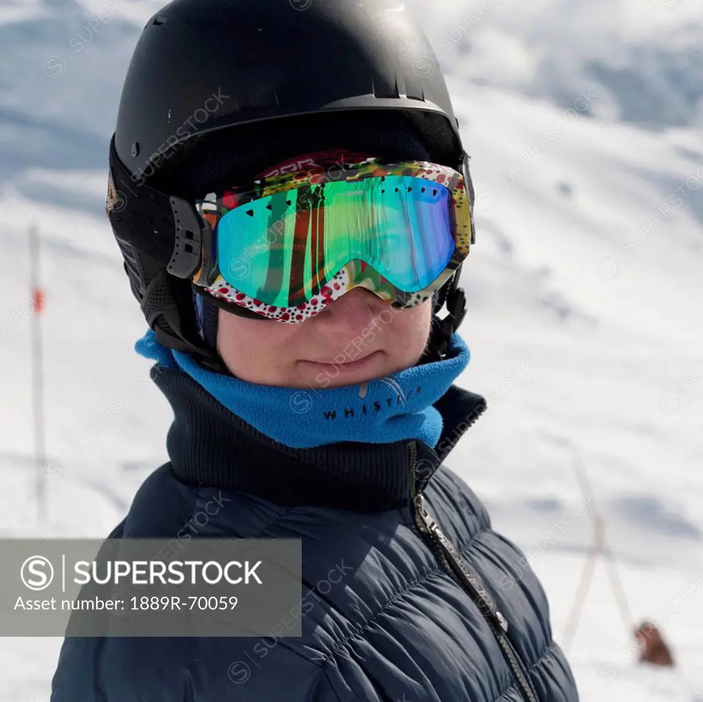 a skier in goggles and helmet at a ski resort, whistler british columbia canada