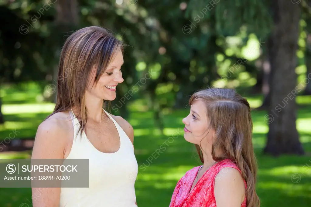 mother with teenage daughter in the park, edmonton alberta canada