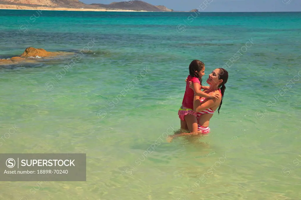 a mother and daughter in the water together at cabo pulmo, baja california sur mexico