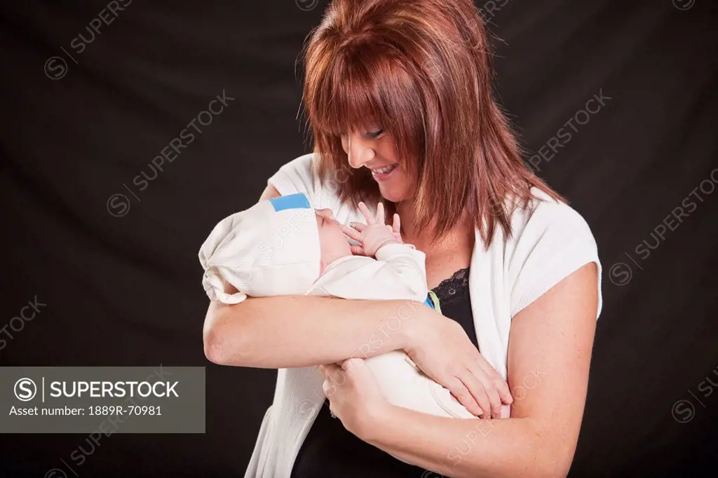 a mother holds her newborn baby, edmonton alberta canada