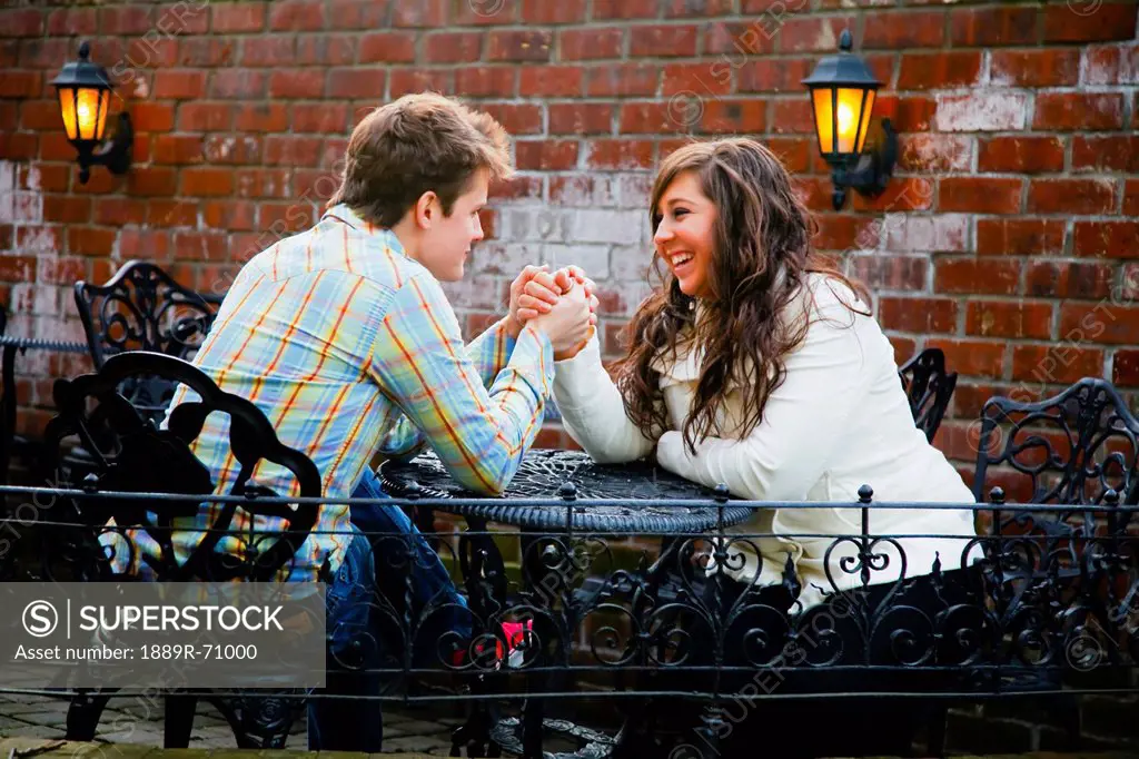 a young couple holding hands at a table, bellingham washington united states of america