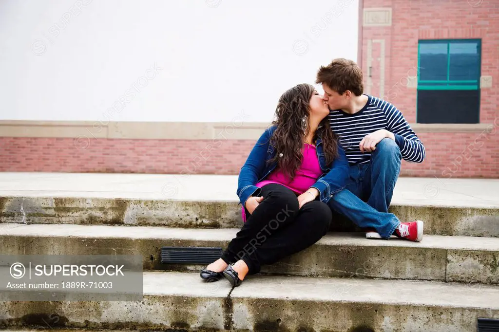 a young couple kissing on steps, bellingham washington united states of america