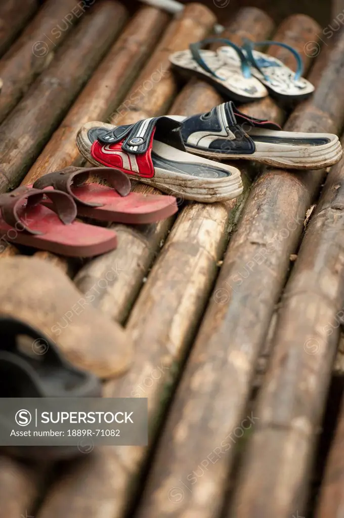 pairs of shoes on bamboo at the noh poh refugee camp, mae sot thailand