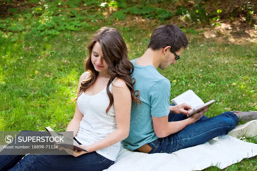 newlywed couple reading together in a park, edmonton alberta canada