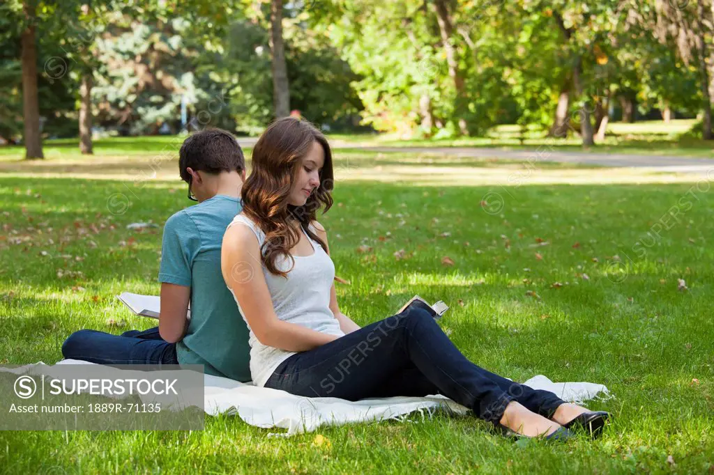 newlywed couple reading together in a park, edmonton alberta canada