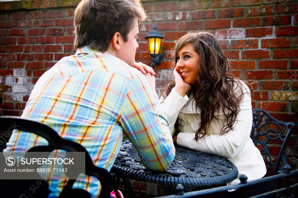 a young man and woman sitting at a table together, bellingham washington united states of america