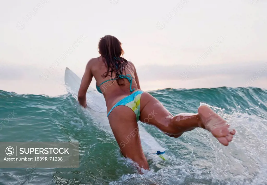 a woman on a surfboard, tarifa cadiz andalusia spain