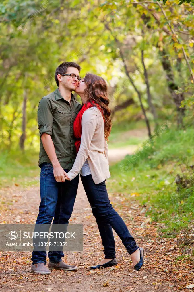 newlywed couple spending time together in a park in autumn, edmonton alberta canada