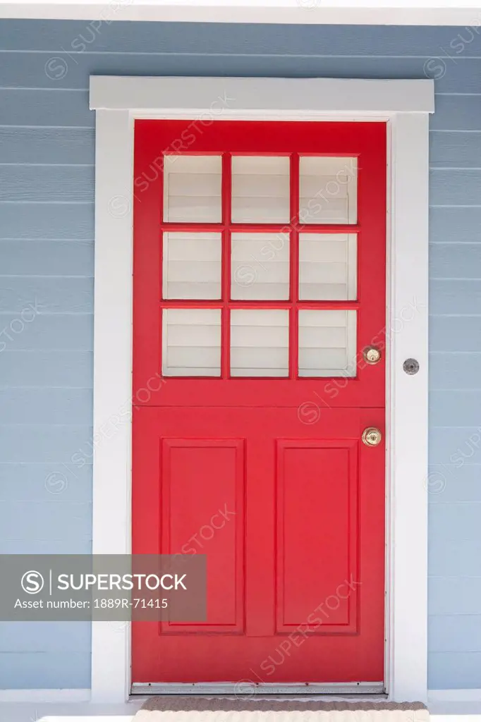red door framed with white trim and light blue siding, palm springs california united states of america