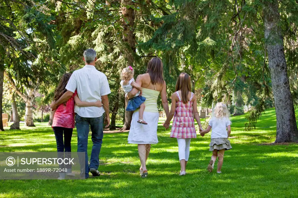 family walking together in a park, edmonton alberta canada