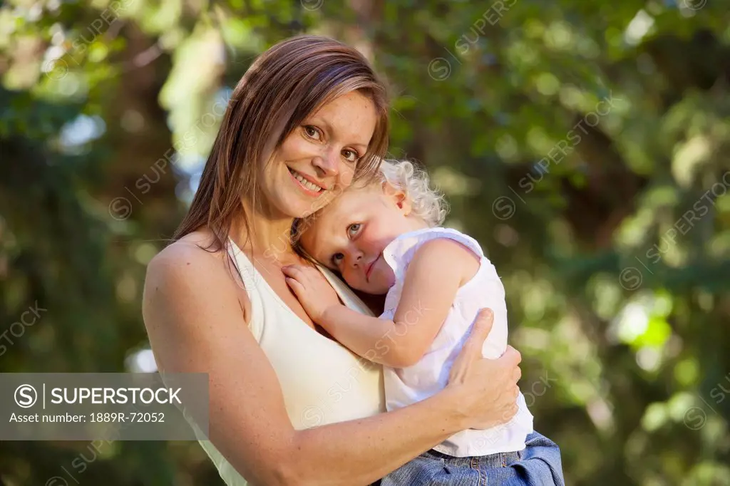 mother holding toddler in a park, edmonton alberta canada