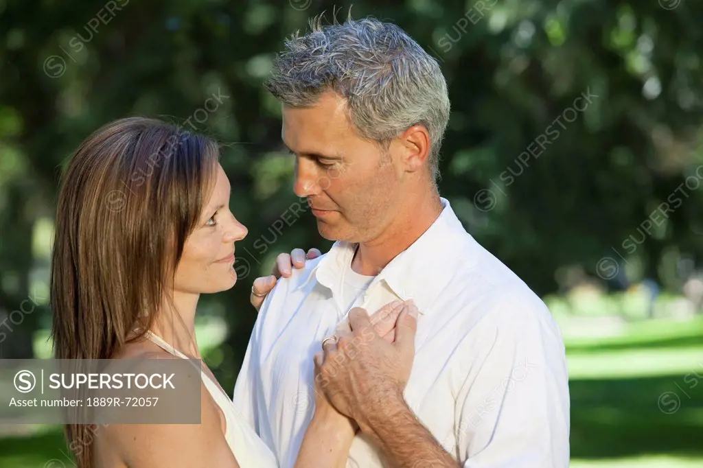 couple embracing in the park, edmonton alberta canada