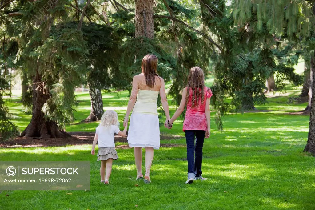 mother and daughters walking in the park, edmonton alberta canada