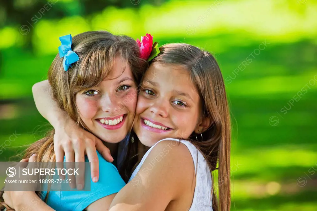 two sisters hugging in a park, edmonton alberta canada