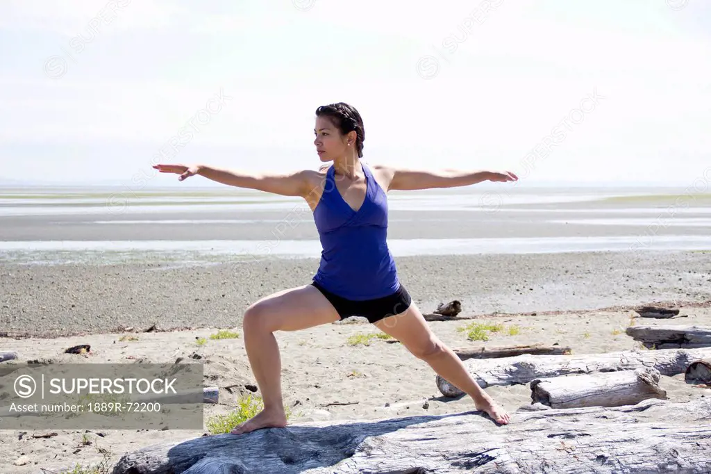 woman doing yoga on a beach, delta british columbia canada