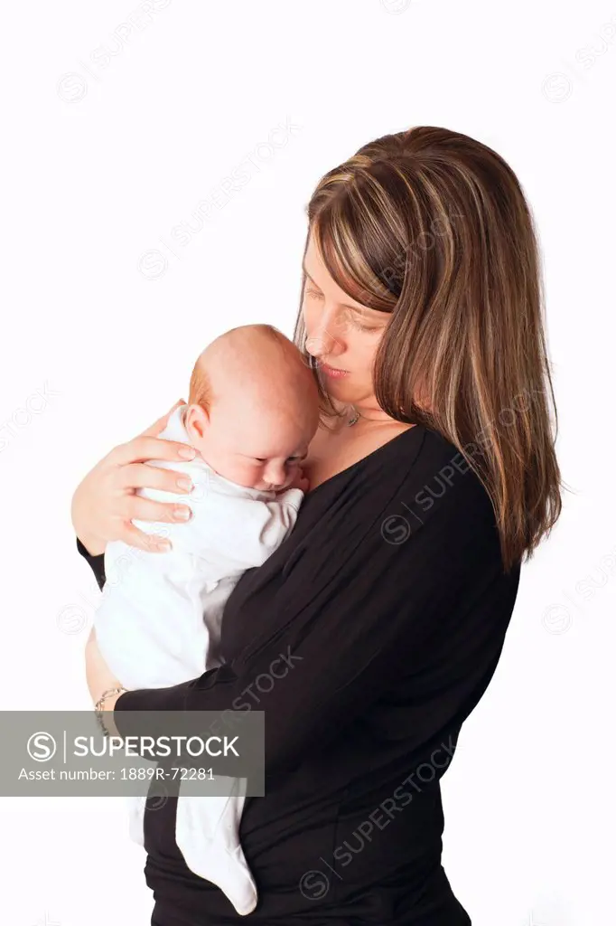 a mother cuddles with her newborn baby, dundas minnesota united states of america