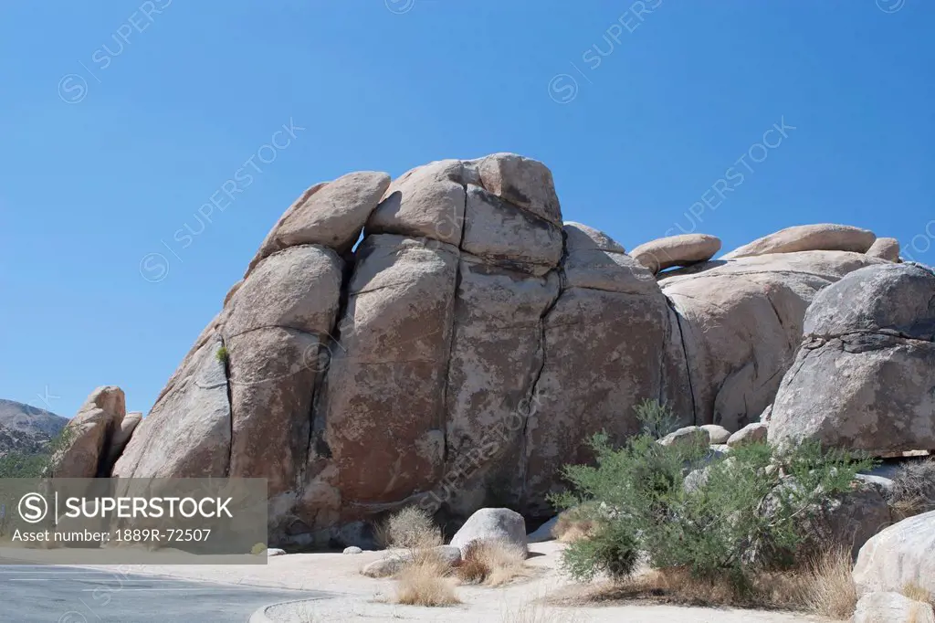 large rounded rock formation in the desert with blue sky, palm springs california united states of america
