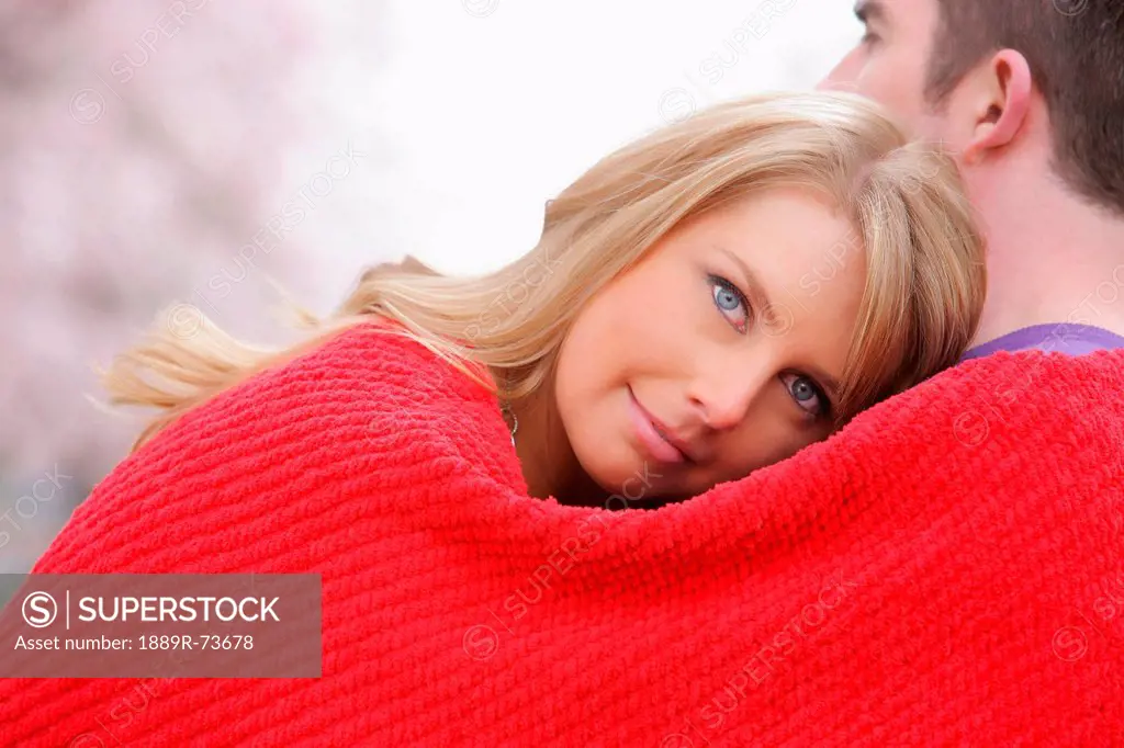 Couple Huddled In A Red Blanket, Portland Oregon United States Of America