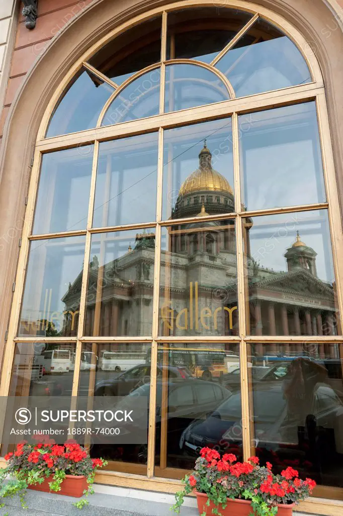 A window reflecting saint isaac´s cathedral and parked cars, st. petersburg russia