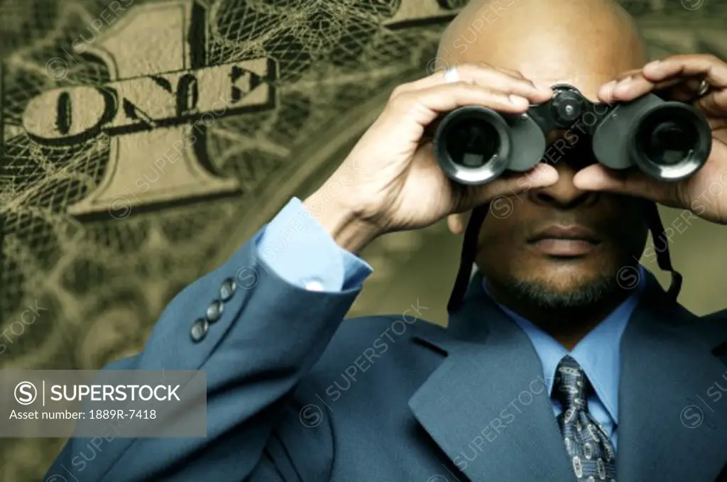 American dollar bill and man with binoculars
