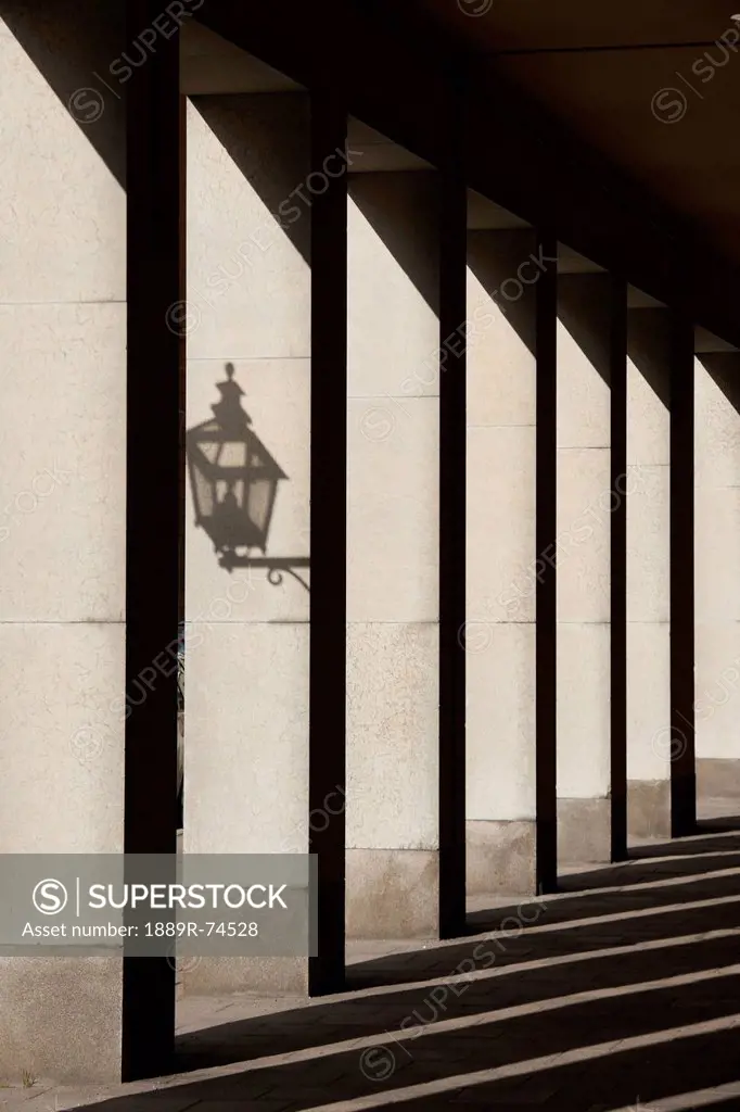 Shadows cast by sunlight shining on pillars and a lantern, stockholm sweden