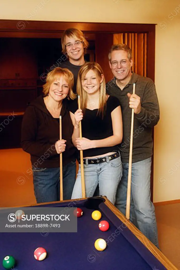 Family playing a pool game