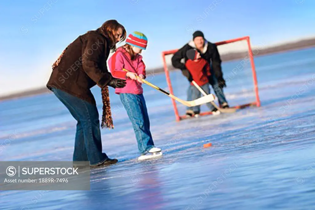 Family playing shinny hockey