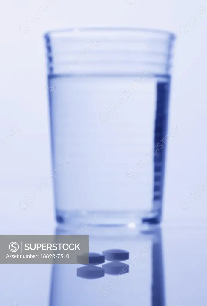 Closeup of pills with water