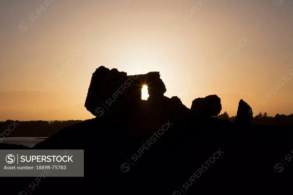 Sunlight Shining Through A Hole In A Rock Formation At Sunset, Clonmacnoise County Offaly Ireland
