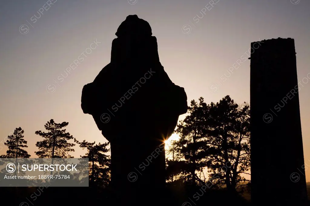 Silhouette Of A Tower And Tombstone At Sunset, Clonmacnoise County Offaly Ireland