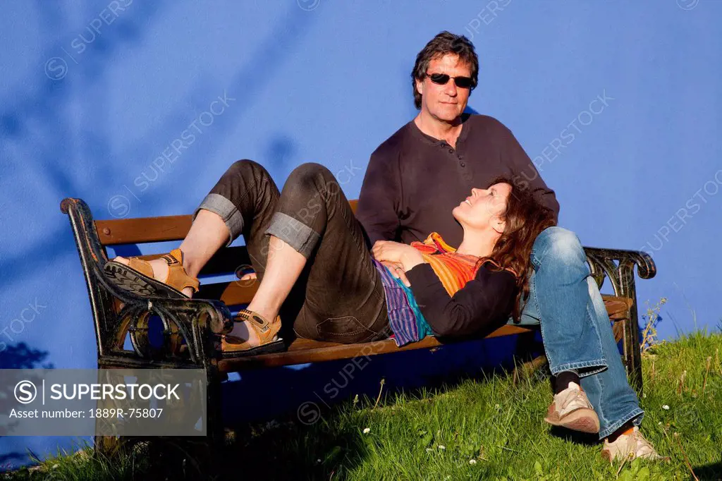 A Woman Rests Her Head In A Man´s Lap On A Park Bench, Eyeries County Cork Ireland