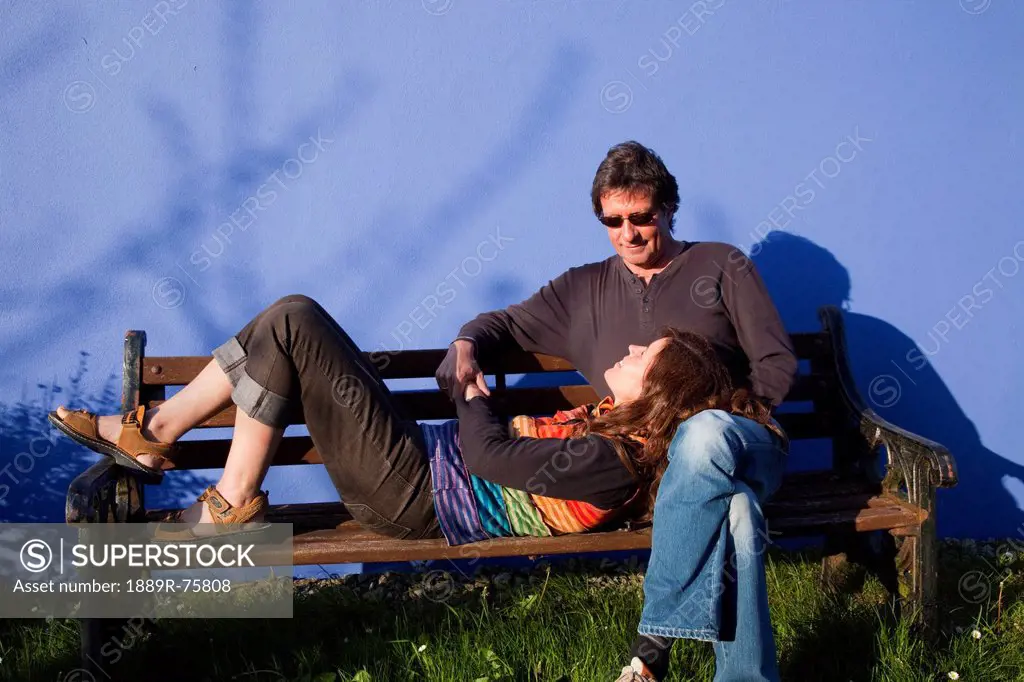 A Woman Rests Her Head In A Man´s Lap On A Park Bench, Eyeries County Cork Ireland