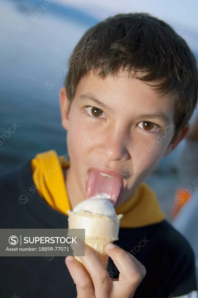 A Boy Licking An Ice Cream Cone, Lake Tahoe California United States Of America