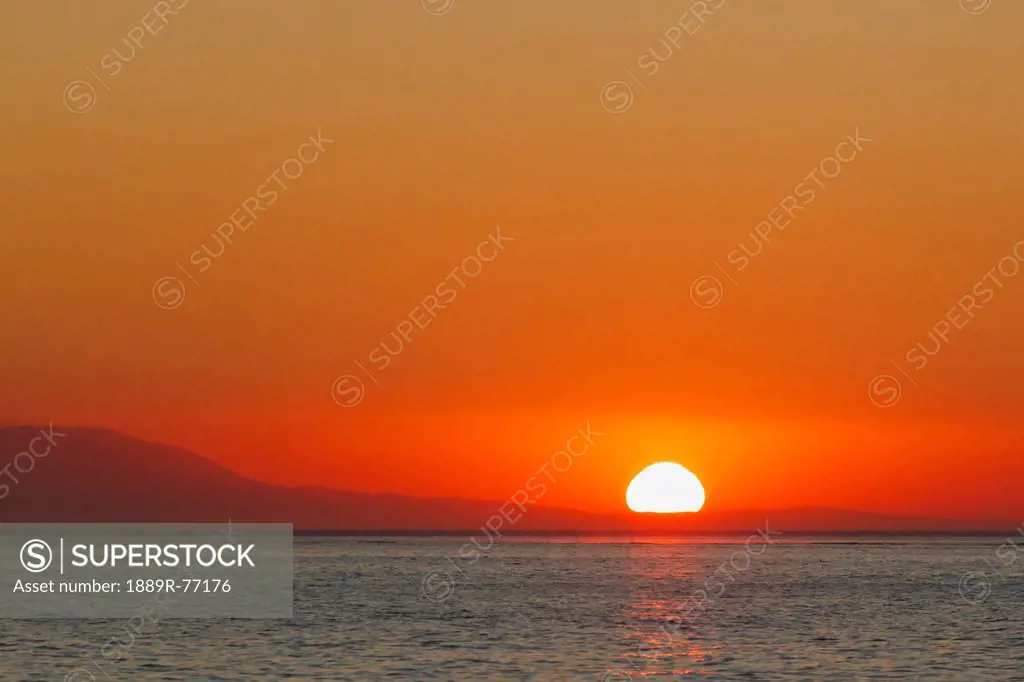 sunrise over malaga bay, torremolinos, costa del sol, malaga province, spain