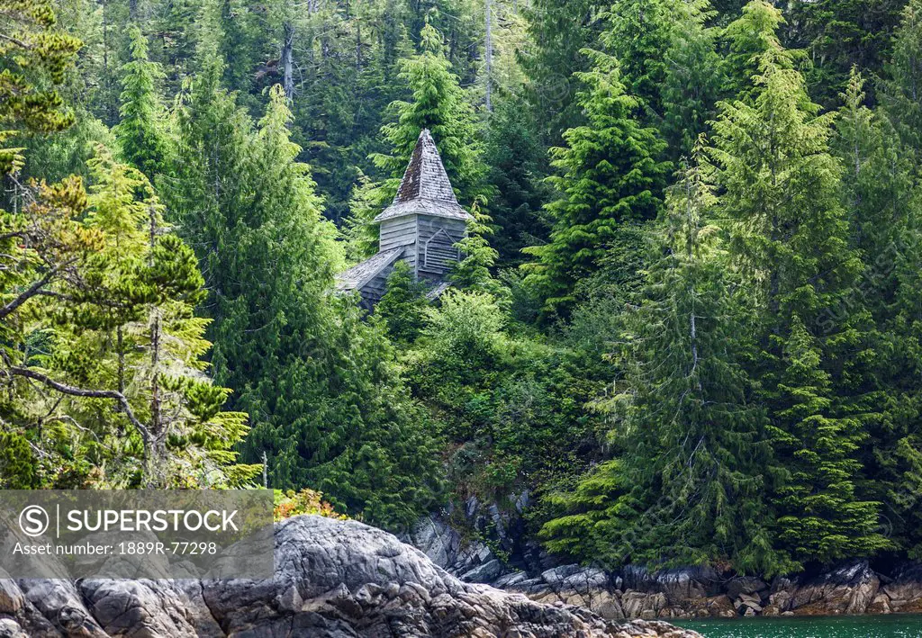 An abandoned wood church surrounded by nature in queens cove in esperanza inlet on the west coast of vancouver island, british columbia canada