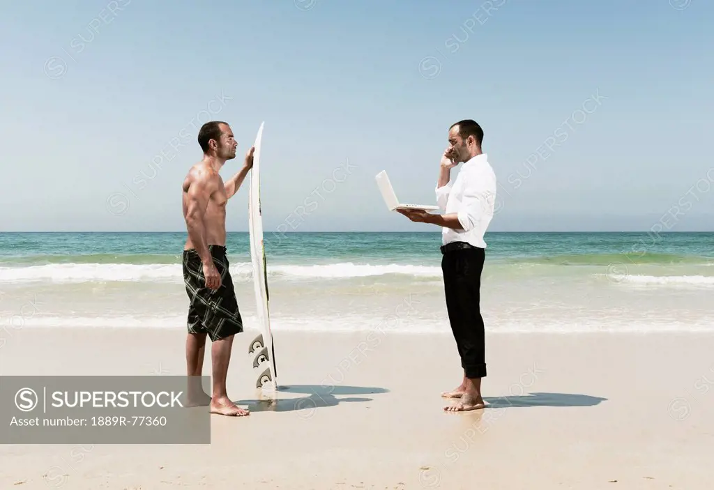 A Man Standing On A Beach Representing Himself With A Surfboard On Vacation And Working As A Businessman, Tarifa Cadiz Andalusia Spain