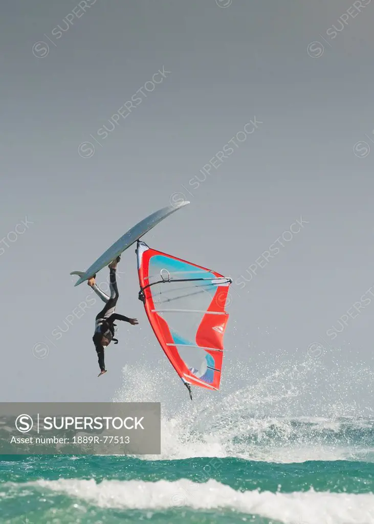A Windsurfer Flips Upside Down On The Water Off Valdevaqueros Beach, Tarifa Cadiz Andalusia Spain